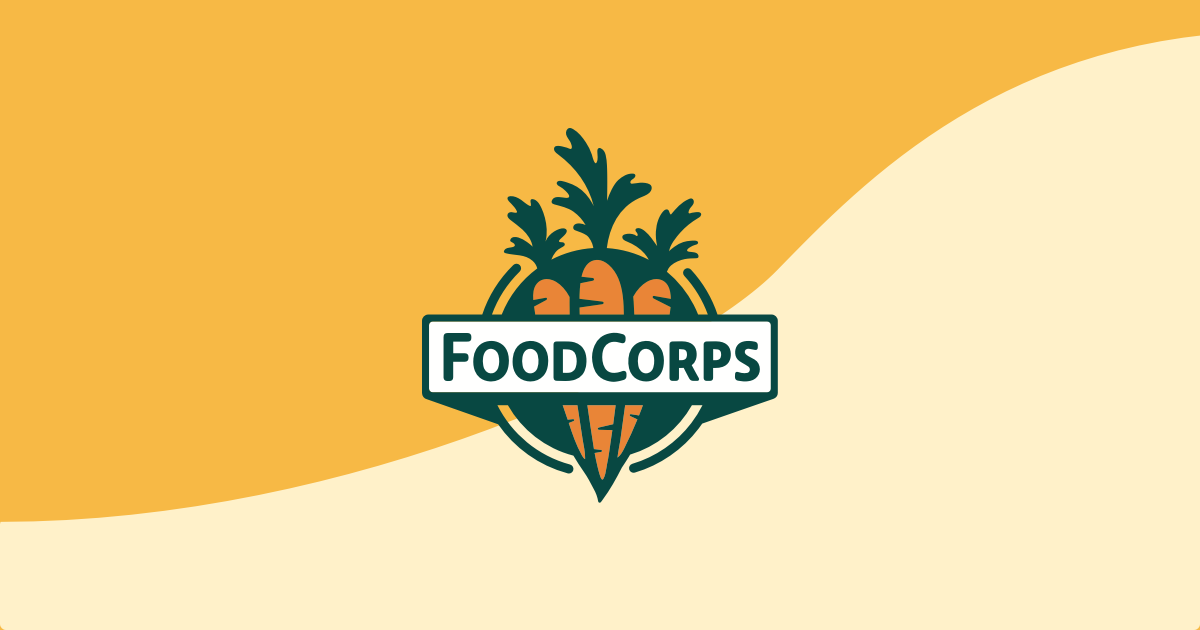 The FoodCorps logo on a two-toned golden background. The Skillet is FoodCorps' hub for news, stories, Kindred updates, and resources.